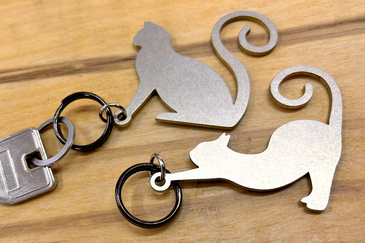 Laser cutting cat shape keychains.